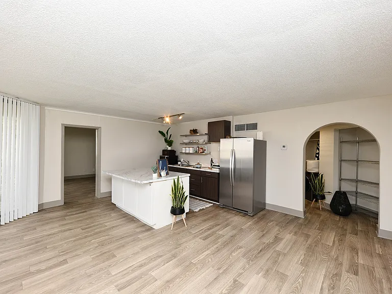 Kitchen and dining area with hardwood-style flooring