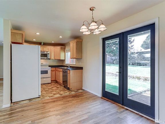 French doors off of the eat-in kitchen open to the backyard. 