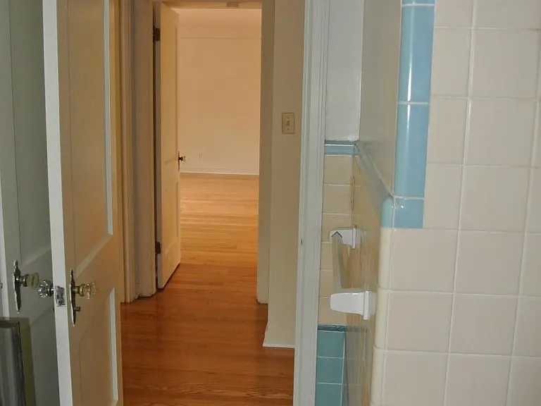 view from bathroom, past two bedrooms into living room.