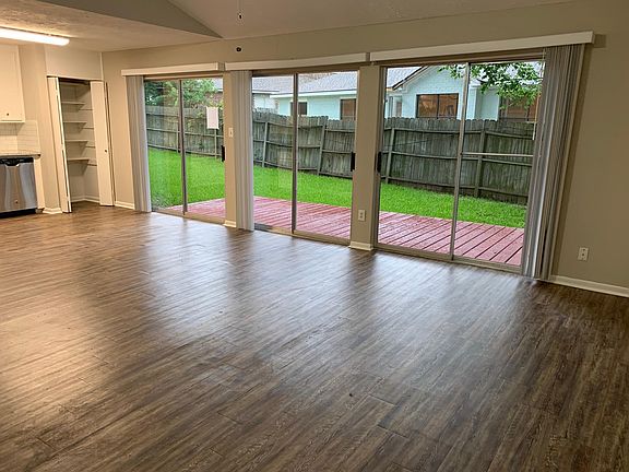 Open concept living, dining, kitchen areas with 3 sliding doors onto back patio