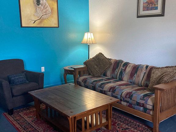 The cozy living room is to right as you walk through the door - please see next photo for the correct photo of the sofa - this photo was taken after the sofas changed