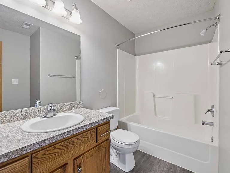 A bright, well-appointed bathroom with timeless finishes offers a comfortable space to refresh and unwind.