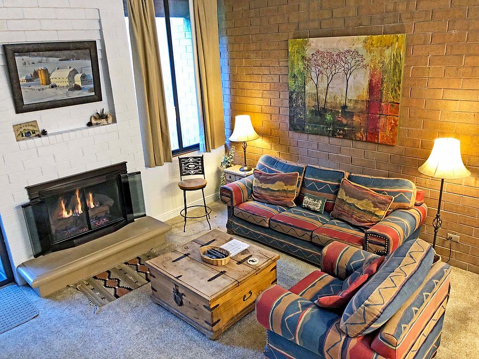 The living room area has a gas fireplace with remote control. The couch can fold out to a queen bed.