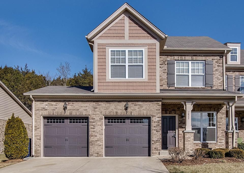End unit with 2 car garage and backs to trees for privacy.