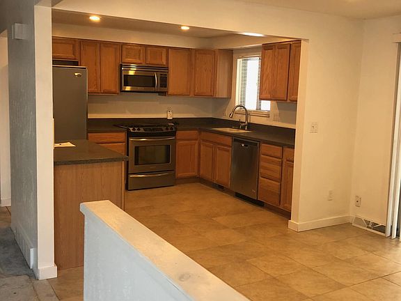 View of kitchen and open dining area, from living room.