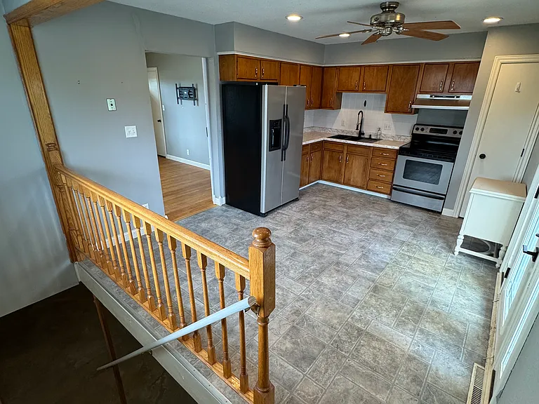 Kitchen and steps to unfinished basement.