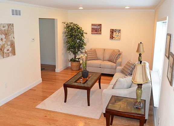 Neutral paint and recessed lighting in living room