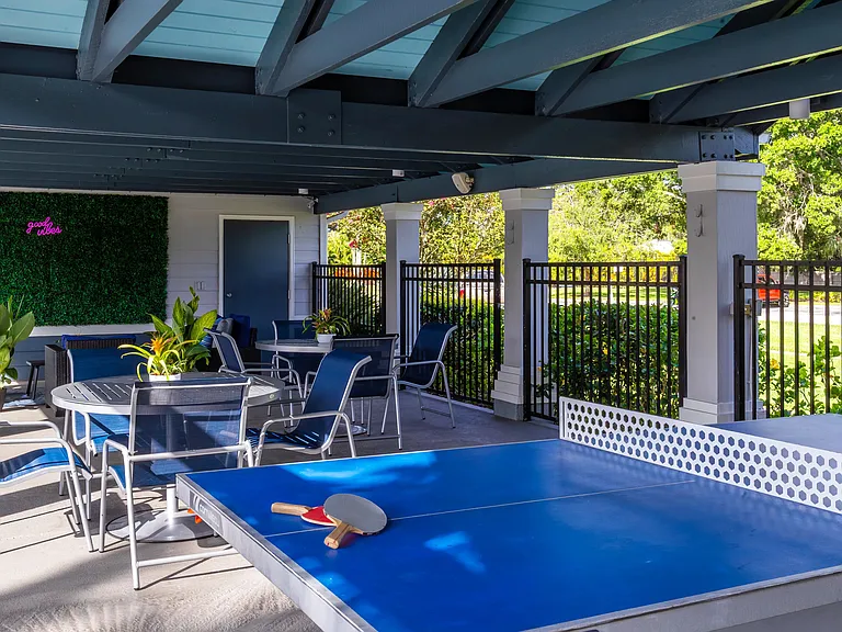 Gather with friends in our inviting covered pavilion featuring comfortable seating, greenery, and a ping pong table for a little friendly competition.