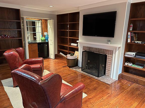 Entry level office + den with patio access and wet bar