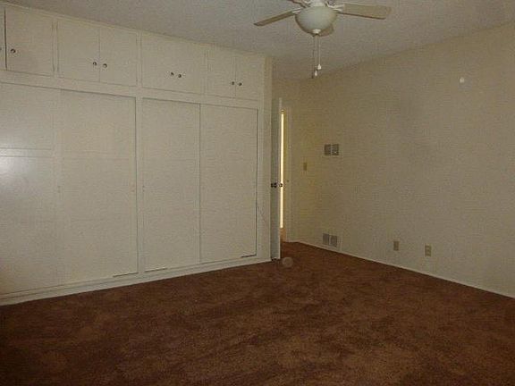 bedroom closet with storage above