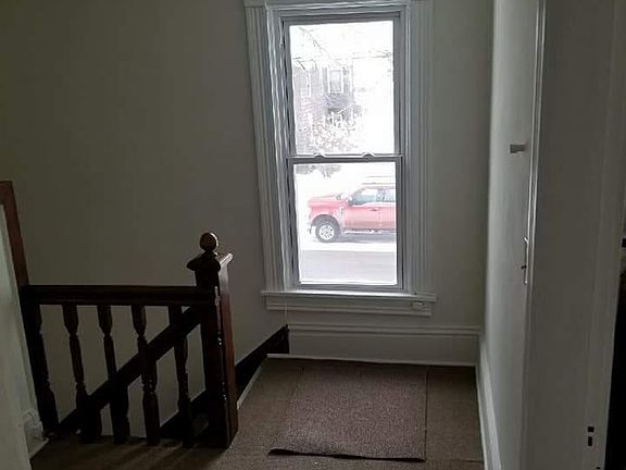 Hallway has place for bench & coat rake