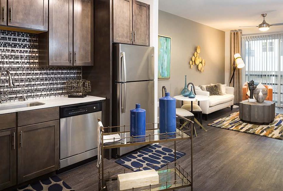 Modern Kitchen with Stainless Steel Appliances, Custom Cabinets, and Tiled Backsplash