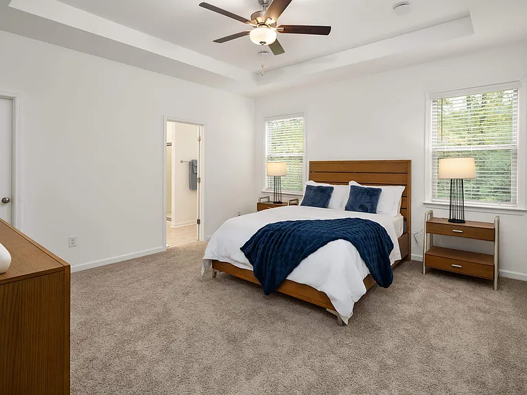 Primary bedroom with king size bed and large window.
