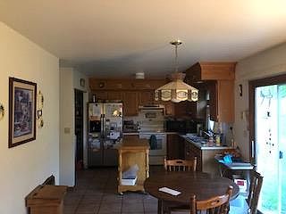 looking into kitchen (refrigerator, washer, dryer stays). small island is movable.