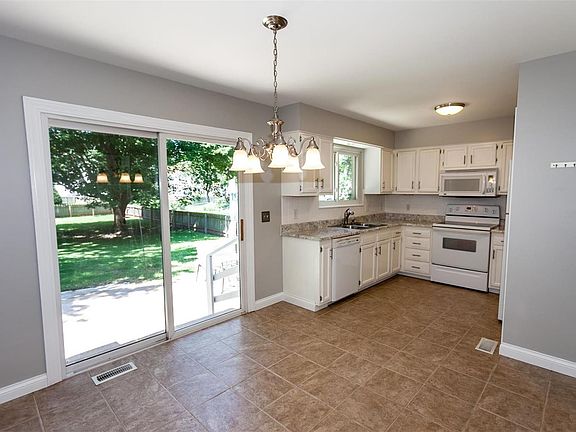 Kitchen features ceramic tile flooring, updated lighting, new counter top with tile back splash & stainless steel sink.