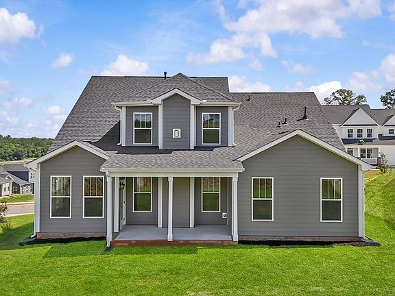 Rear exterior of two story home with large windows at The Grange by DRB Homes in Clemson, SC