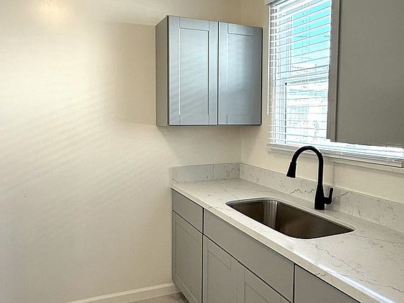 Brand new tile floor, cabinets, countertop and fixatures with a large window