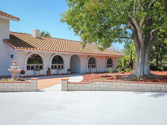 A lovely fountain and water wise plants adorn the front yard.