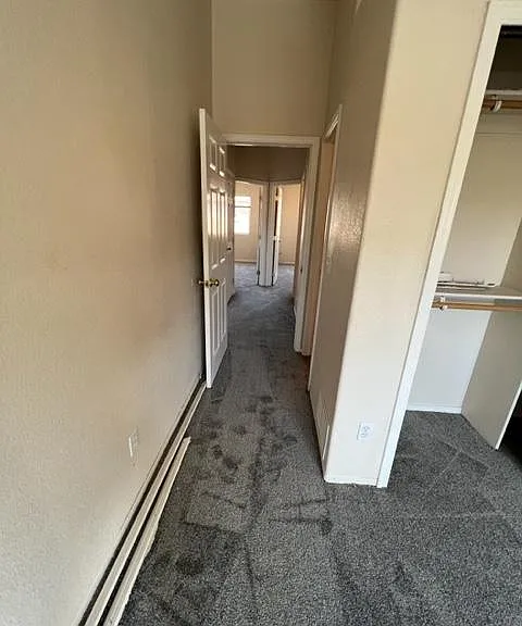 Second floor bedroom hallway, and 2 bedrooms in the background.
