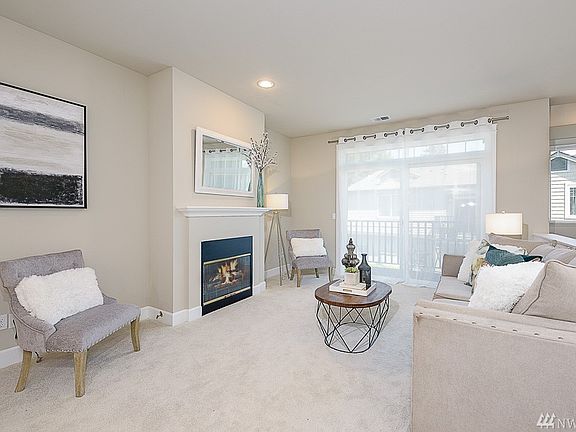 Family room features gas fireplace and outdoor deck access through sliding glass doors.