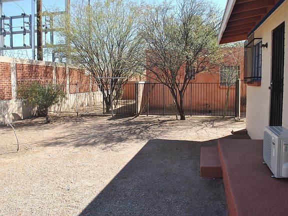 Large back yard. There is a utility substation behind the large brick wall.