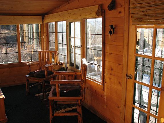 sunroom with new carpet and french door.