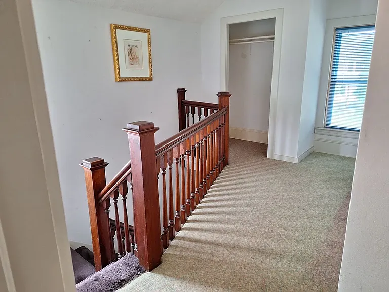 Landing at top of stairs, can be used for office space, has hall closet