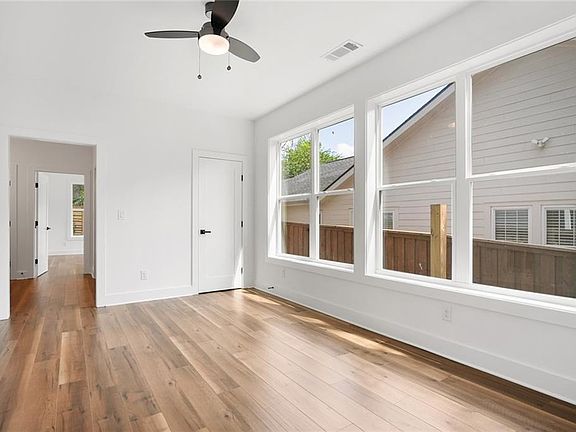 Downstairs den with storage and wall of windows for ample natural light