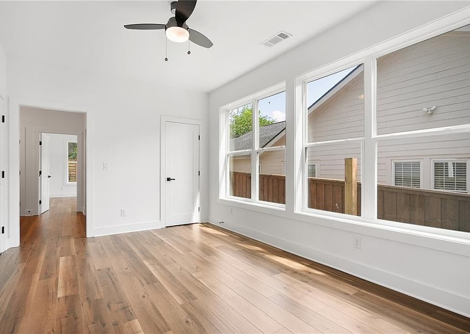 Downstairs den with storage and wall of windows for ample natural light