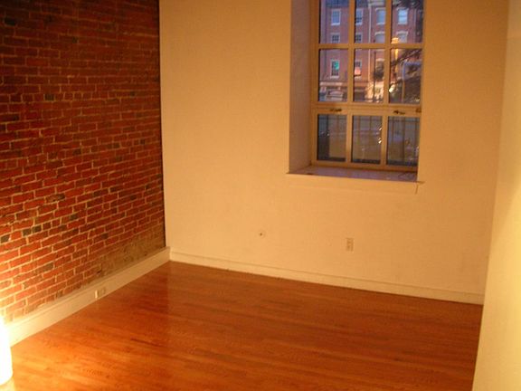 Bedroom with exposed brick