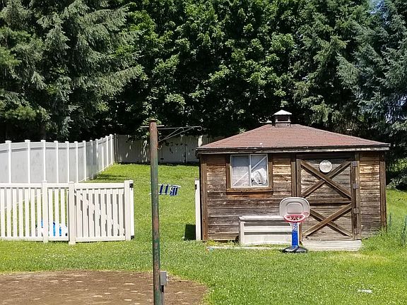 Fenced in yard with storage shed