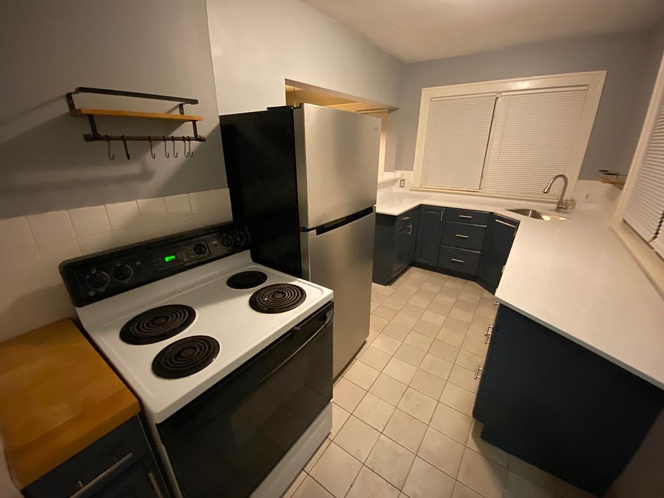 Kitchen with new quartz countertop, stainless steel sink, and faucet