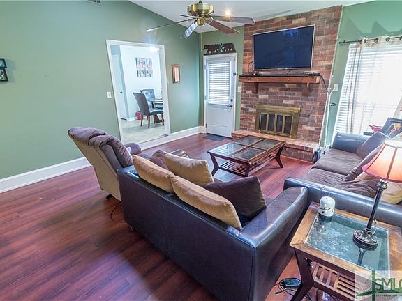 Spacious living room with masonry fireplace