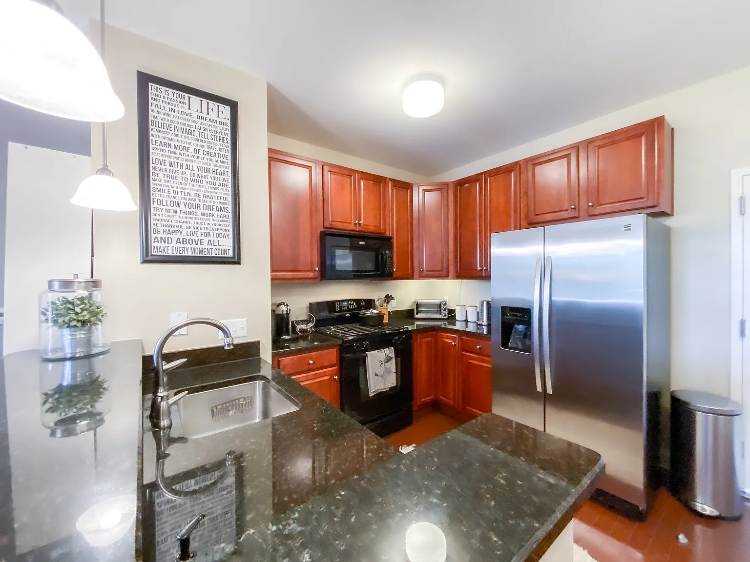 Granite peninsula with undermount sink overlooking the kitchen