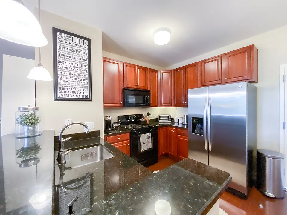 Granite peninsula with undermount sink overlooking the kitchen