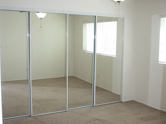 Spacious bedroom with celing fan. Large closet with mirrored sliding doors