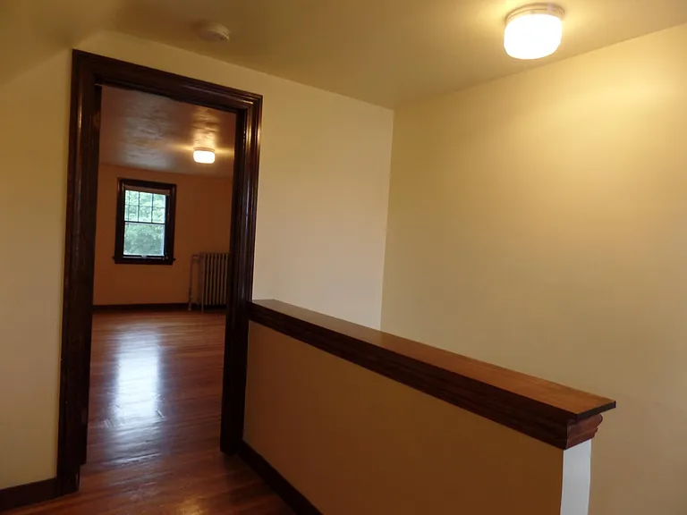Landing at the top of the stairs. Upper Bedroom through door.
