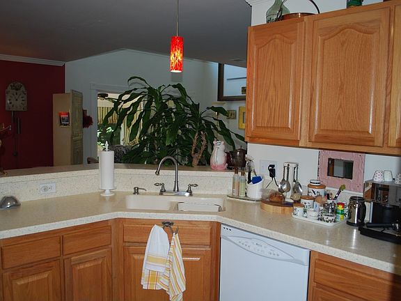 Kitchen with solid surface countertops and newer appliances.