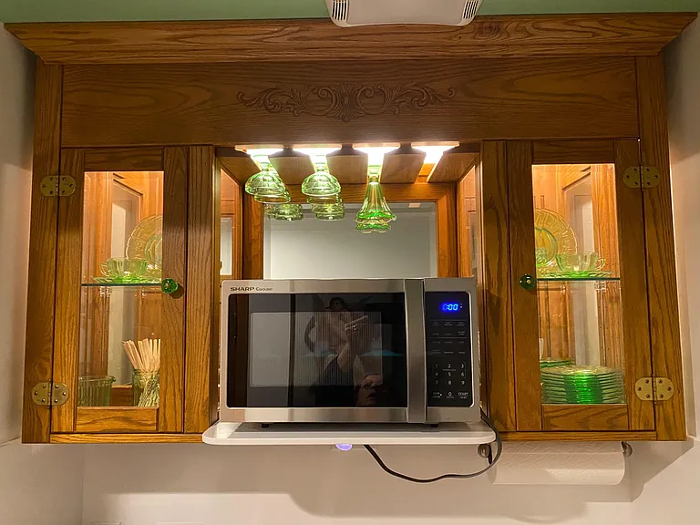 Oak & Beveled Glass Vitrine Cabinet w/lighted Dish storage & Mirrored backs, boasting a Stemware Rack o/Stainless Steel Microwave Oven