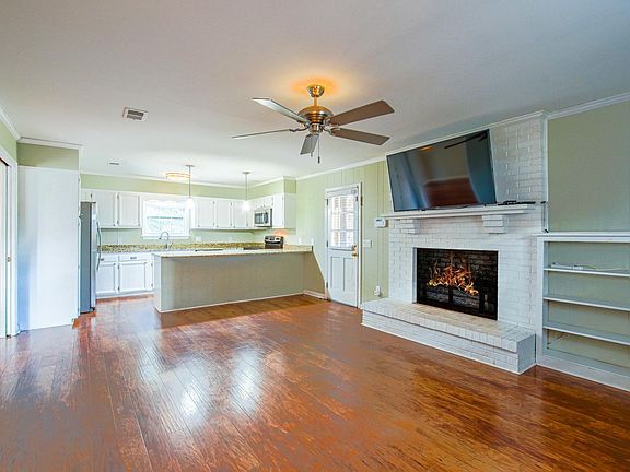Open kitchen, gas fireplace, and mounted TV.