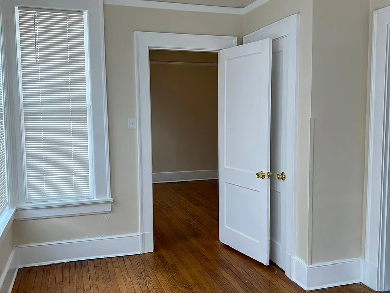 2nd Bedroom #2 view. Forward doorway leads into larger bedroom. Right doorway leads into kitchen.