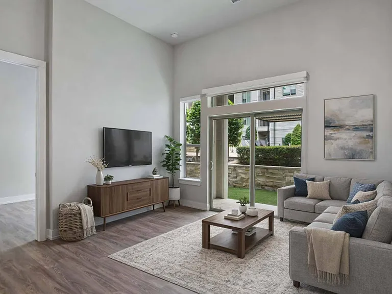 Enjoy seamless indoor-outdoor living in a bright living room that opens to a private patio.