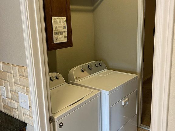 Laundry room connecting garage to kitchen.