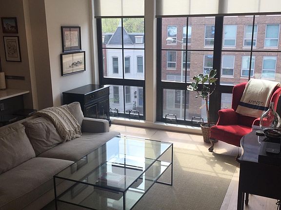 Living room with hardwood floors and floor-to-ceiling, opera
