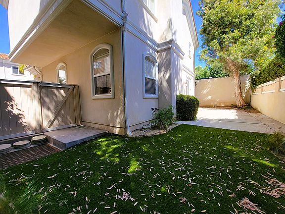 backyard with concrete patio for outdoor dining... large mature trees