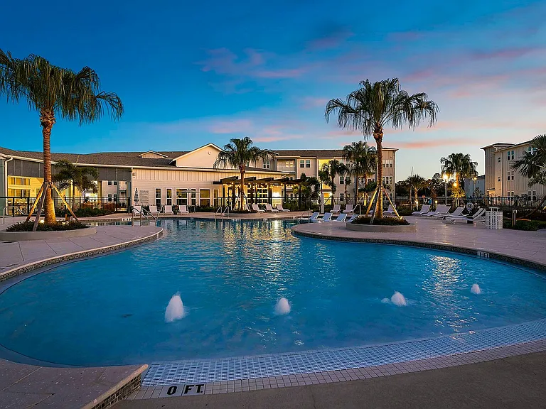 Experience serene evenings by the illuminated pool in our luxurious apartment community.