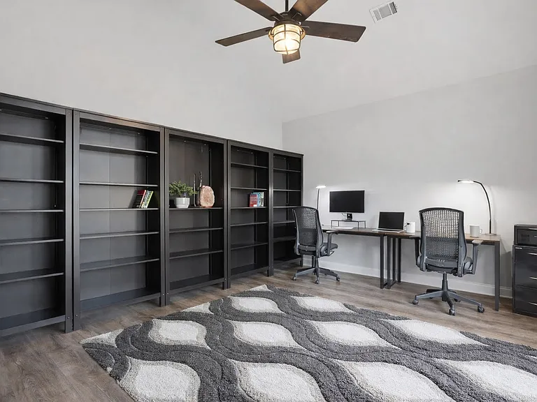 Flexible office setup with natural light and room for multiple workstations