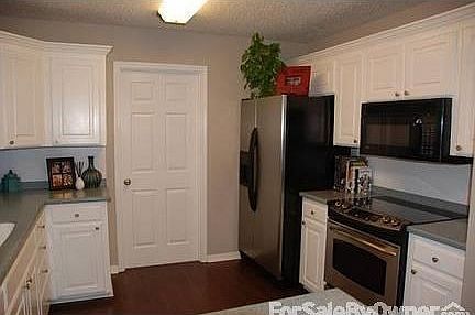 Kitchen : Updated floors, countertops & appliances. Door pictured opens to laundry room.
