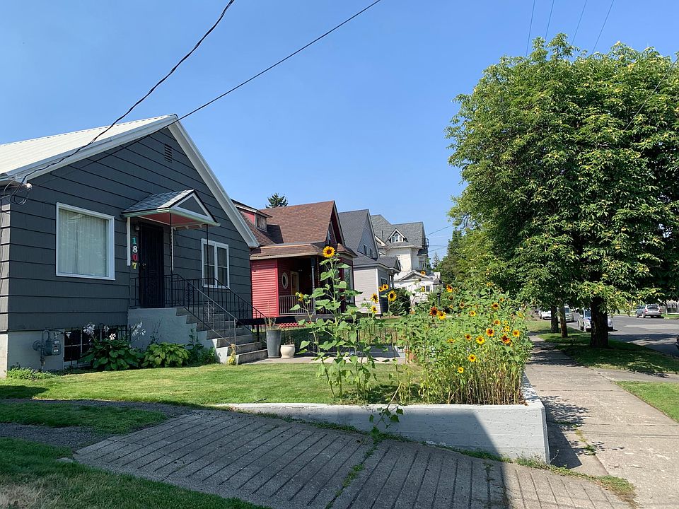 Off-street parking for two cars off tree-lined street.