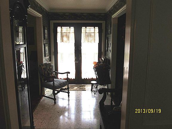 Front entry features double leaded glass front doors and wood flooring.